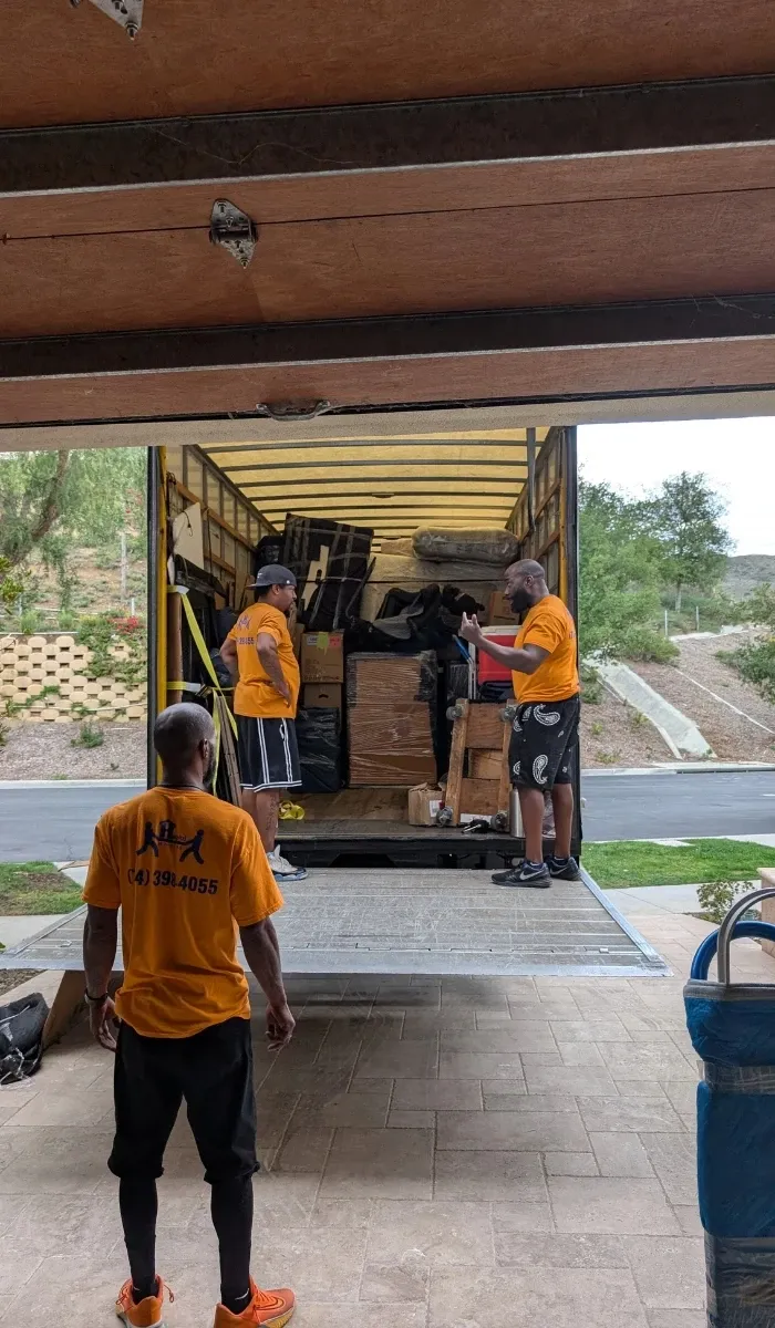 Helpful Moving team loading furniture into a moving truck in Orange County