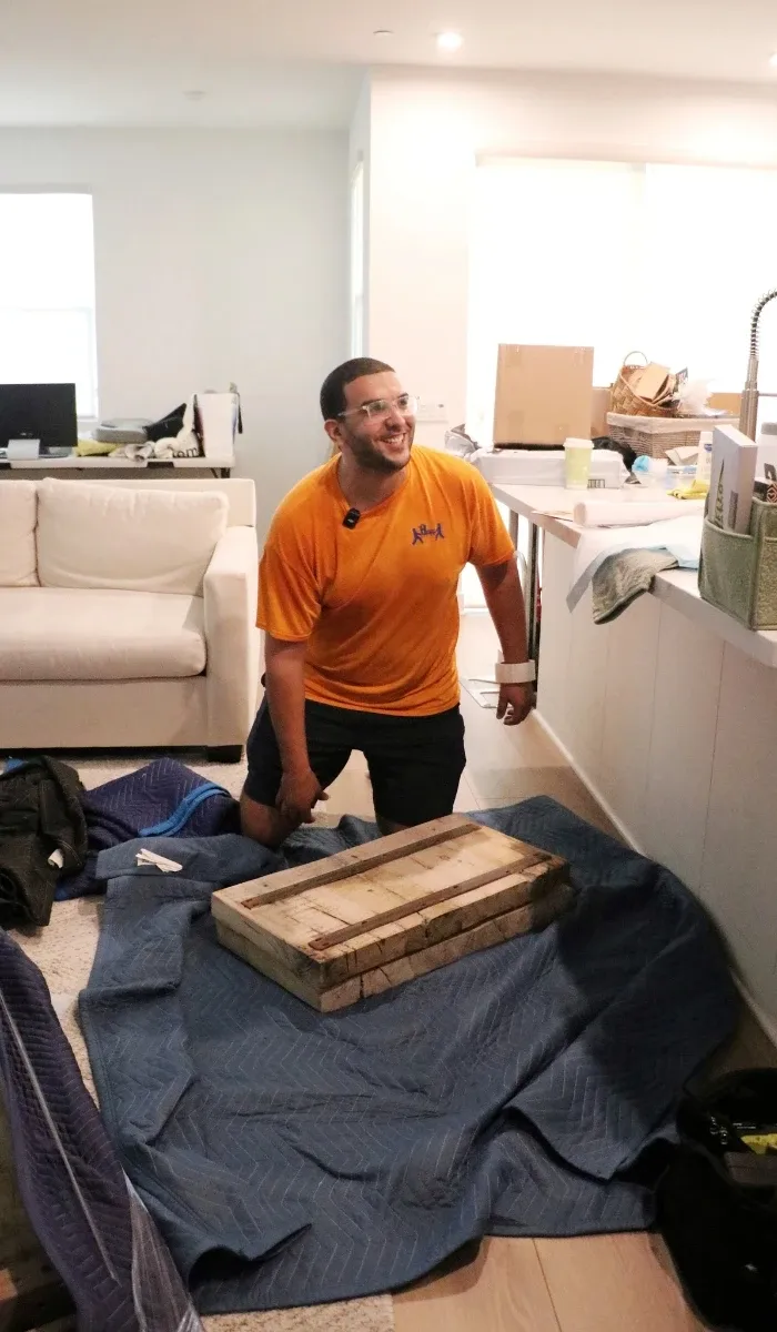 Owner Noah packing fragile items on a Helpful Moving job