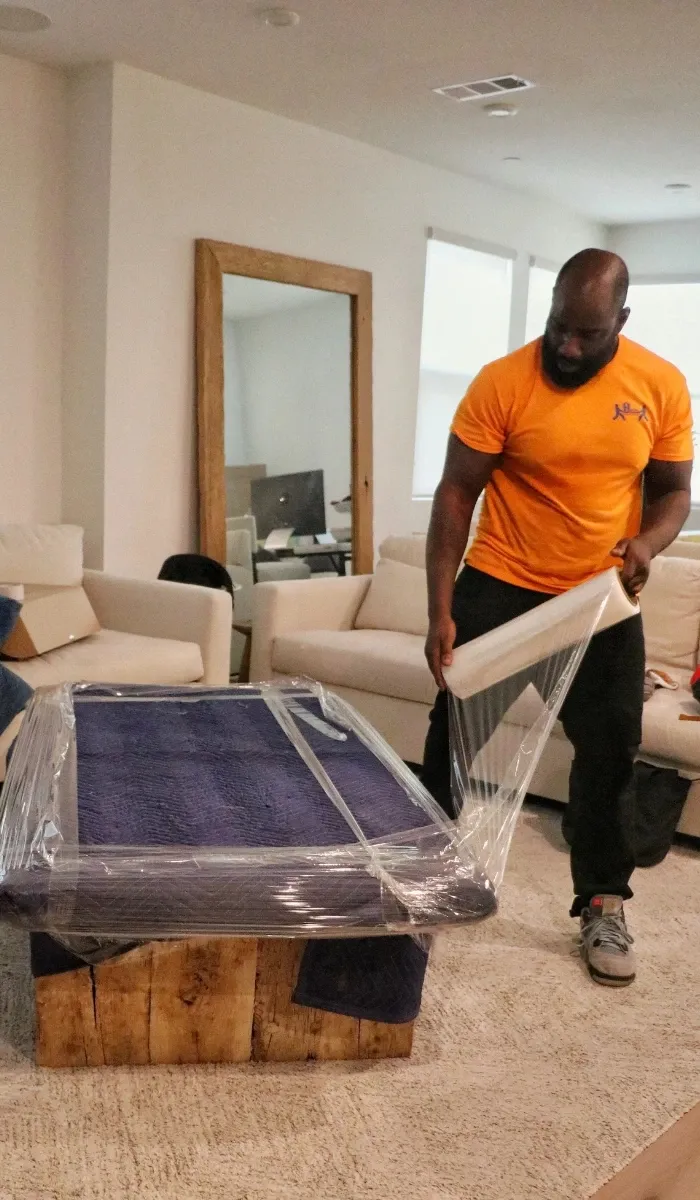 Furniture protected with moving blankets and stretch wrap by Helpful Moving
