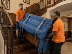 Helpful Moving professional packer wrapping fragile items with premium materials